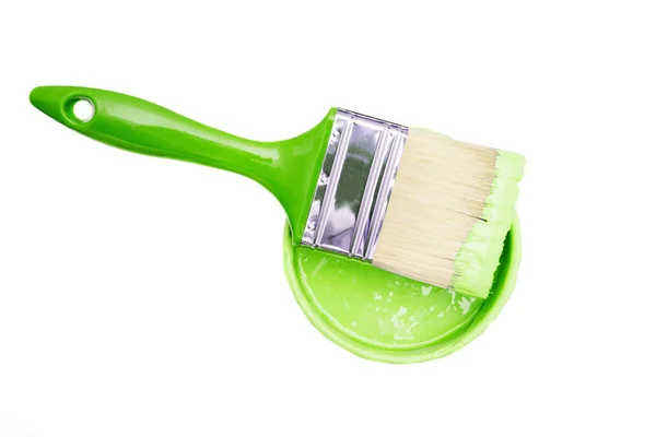 Open, painted bucket and paintbrush on a white backdrop. — Stock Photo, Image