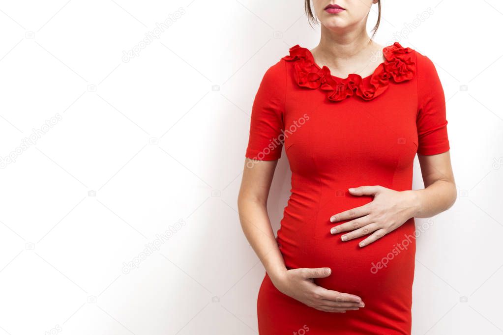 Young, pregnant woman on white background