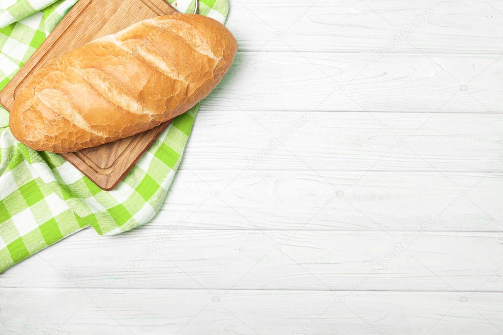 Fresh bread with napkin on kitchen table