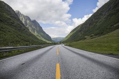 Muhteşem manzaralar boyunca uzanan boş yollar, kuzey fiyortlarına yakın yollar, inanılmaz dağlar, karlı zirveler, bol bitki örtüsü.