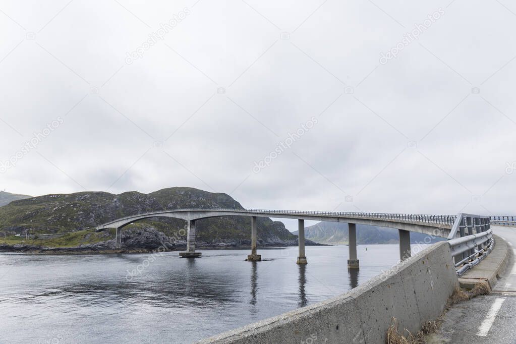 bridge over the water connecting an island to a Norwegian fjord