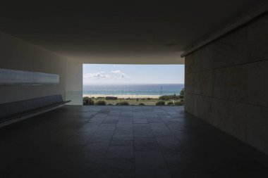 Dışarıdaki manzarayı gözlemlediğimiz bir pencereden berrak bir günde sakin mavi denizi görebiliriz.