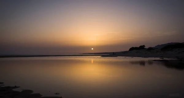 landscape of a sunset in the sea, the sky and the sea are tinged with orange colors