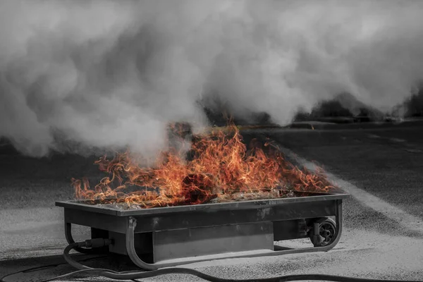 closeup of a controlled fire, orange colors and smoke