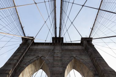 Brooklyn Köprüsü, köprünün içinden fotoğraf, gökyüzünde geometrik şekiller yaratan kemerlerden birinin perspektifi, ABD bayrağını görebilirsiniz, New York 'un fotoğrafları.