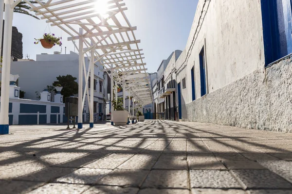 street of a fishing village with white and blue facades