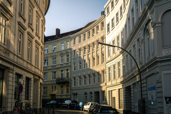The sun hits the facade of the curved buildings along Bruderstrasse in Hamburg on a warmsummer evening