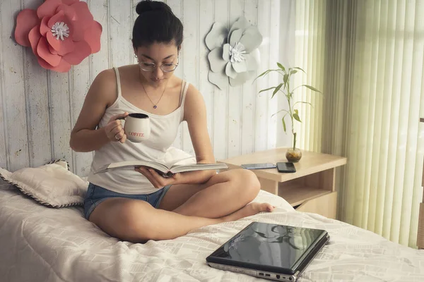 woman drinking coffee in bed disconnecting from technology