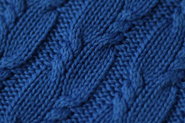 Örgü örülmemiş örülmüş örülmüş kumaş. Örgü süveter, ekose, atkı. Örgü arka plan. Klasik Mavi Renk 2020