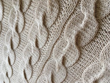 Bej örgülü örgü el yapımı yakın plan.