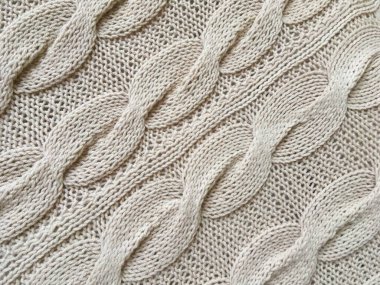 Bej örgülü örgü el yapımı yakın plan.
