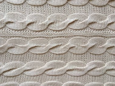 Bej örgülü örgü el yapımı yakın plan.