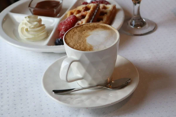 Cup of coffee. Breakfast Belgian waffles and berries