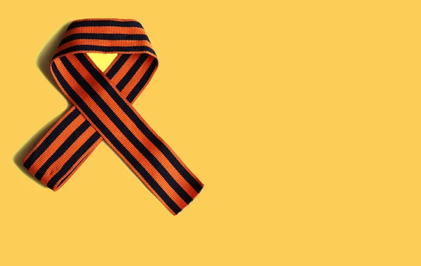 Ribbon of St. George on the background for Victory Day. May 9, 2020 - 75 years of Victory in the Great Patriotic War. Flat lay, copy space, top view.