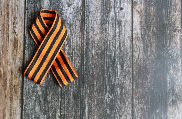 Ribbon of St. George on the background for Victory Day. May 9, 2020 - 75 years of Victory in the Great Patriotic War. Flat lay, copy space, top view.