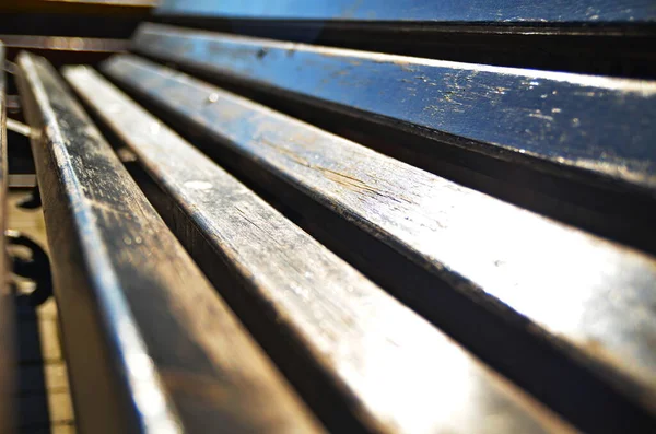 old wooden bench, wooden slats, stripes, parallel lines, at an angle, direction