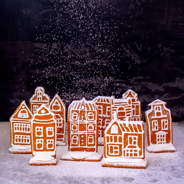 Little gingerbread houses with glaze standing on table