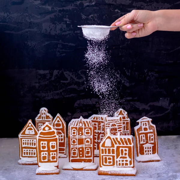 Little gingerbread houses with glaze standing on table