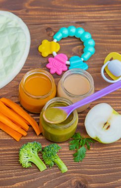 Baby food. Mashed vegetables and fruits in jars. Selective focus. clipart