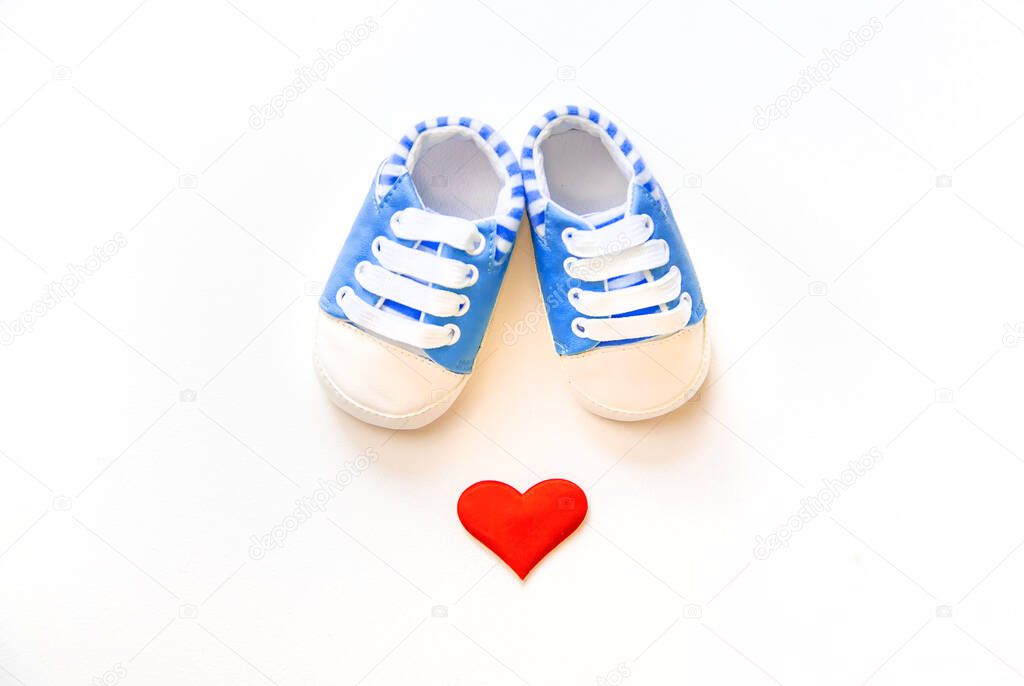 baby booties and heart isolate on a white background. Selective focus.