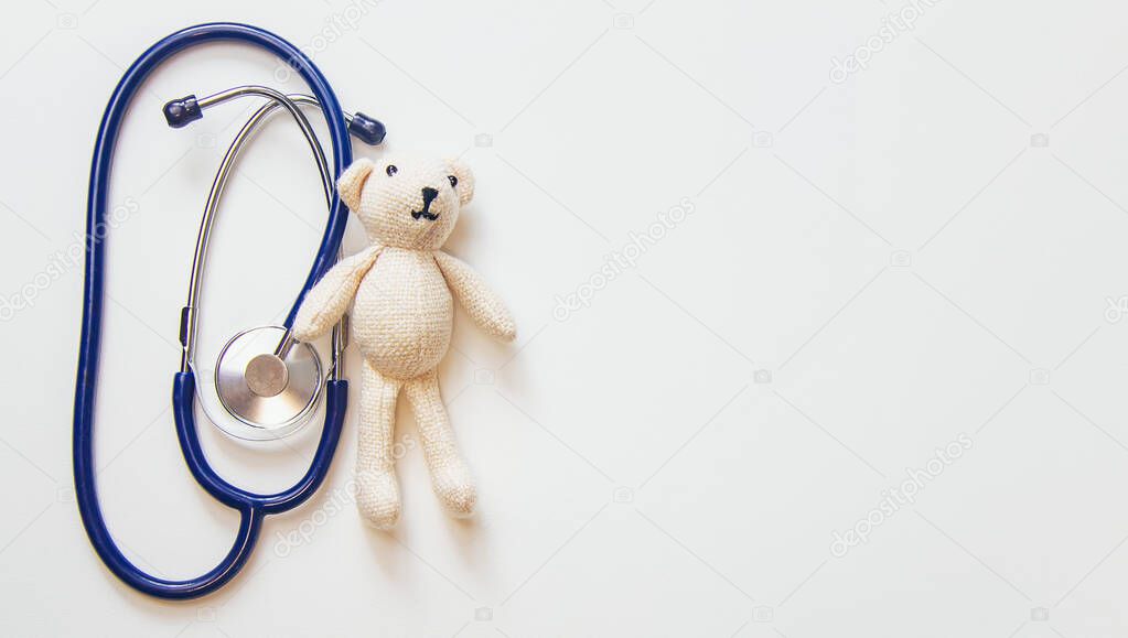 stethoscope and teddy bear isolate on a white background. Selective focus.