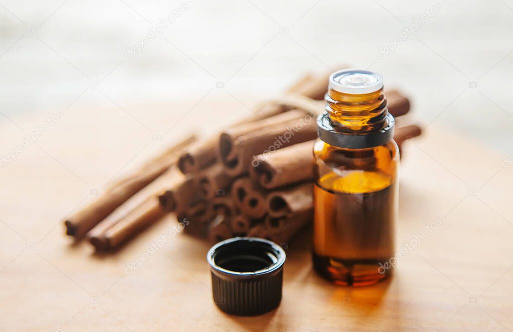Cinnamon essential oil in a small bottle. Selective focus.