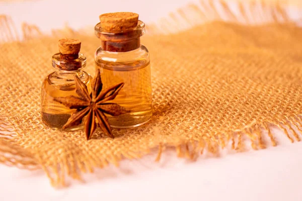 Cinnamon essential oil in a small bottle.Star anise oil in a small bottle. Selective focus.