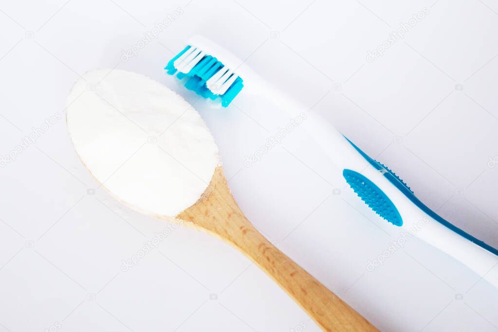 baking soda on a spoon and a toothbrush. selective focus