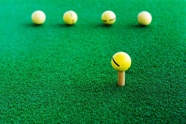 Golf training balls on green grass.