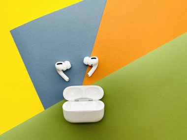 Shanghai/China - February 26, 2020: Newest AirPods Pro on colorful paper with copy space. 