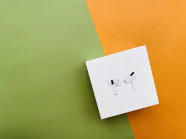 Shanghai/China - February 26, 2020: Newest AirPods Pro on colorful paper with copy space. 