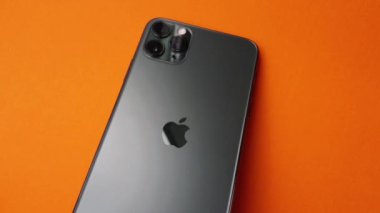 Shanghai, China: March 2, 2020: A hand opening case of Apple Airpods Pro with iPhone 11 Pro Max on isolated background. Airpods Pro is latest version of Airpods.