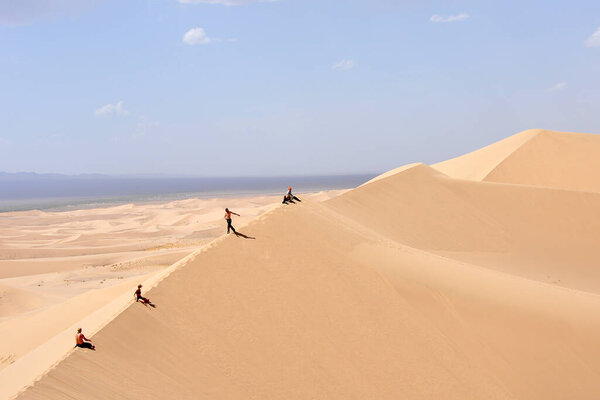 travelers in the sand dunes of the Gobi desert