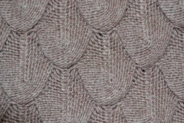 Knitted texture with patterns in light brown.Fashionable concept. — Stock Photo, Image