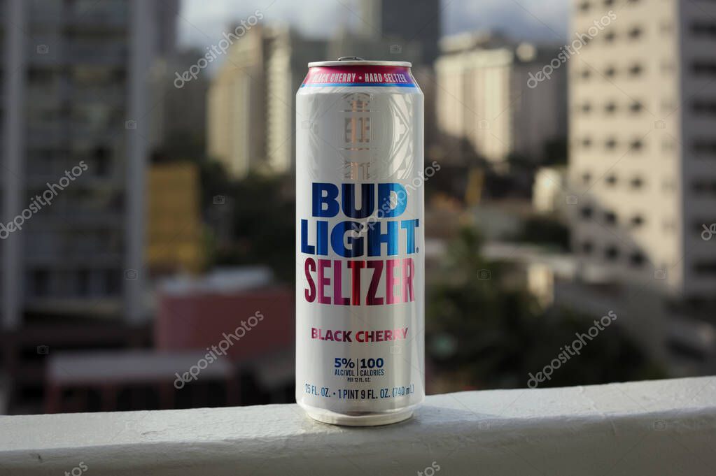 Honolulu, Hawaii - April 13, 2020: Product photo of Budlight seltzer black cherry flavor 25 oz. can on the balcony with the city view in the background.