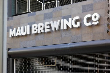 Honolulu, Hawaii - April 28, 2020: Closed store front and name logo of successful microbrewing company Maui Brewing Co. on Kalakaua Avenue in Waikiki.