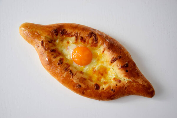 Georgian cuisine, appetizing khachapuri with cheese and raw egg yolk