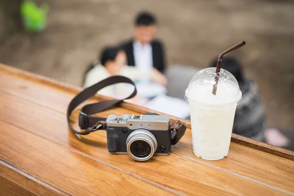 Vintage-Kamera mit Eiskaffee auf Holztisch — Stockfoto