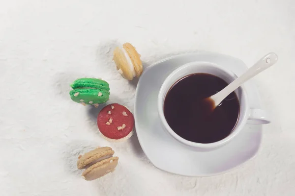 Colourful french macaroons with cup of coffee — Stock Photo, Image