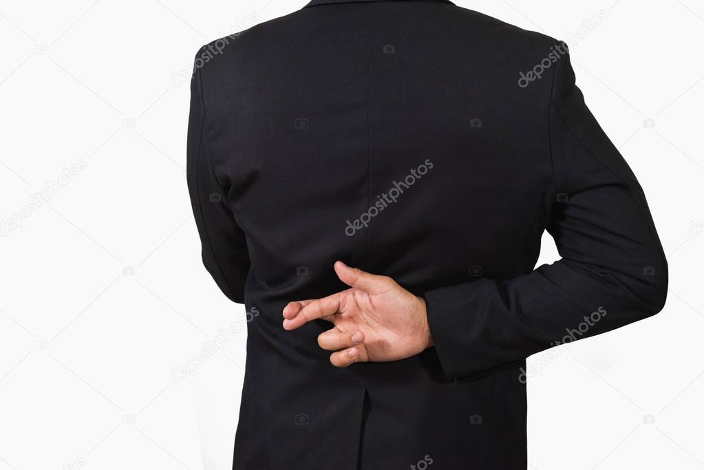 Businessman in dark suit with crossed fingers behind his back