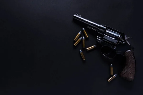 Gun with bullets on black background — Stock Photo, Image