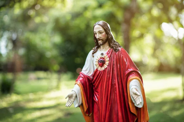 Jesus Christ Statue on green background Stock Photo