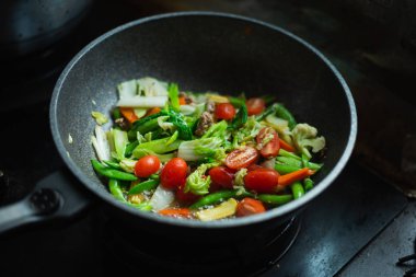 Mutfaktaki tavada kızarmış sebze.