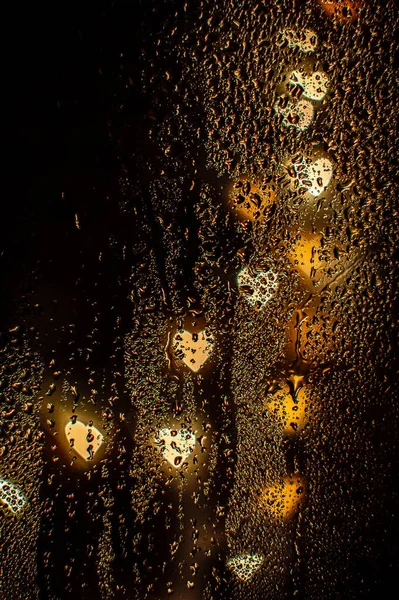 Blurred Heart Shaped Gold Lights Wet Glass — Stock Photo, Image