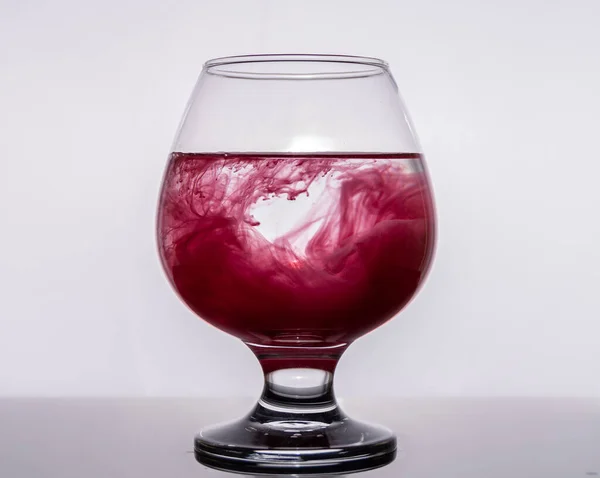 Colored paints were poured into a glass of water