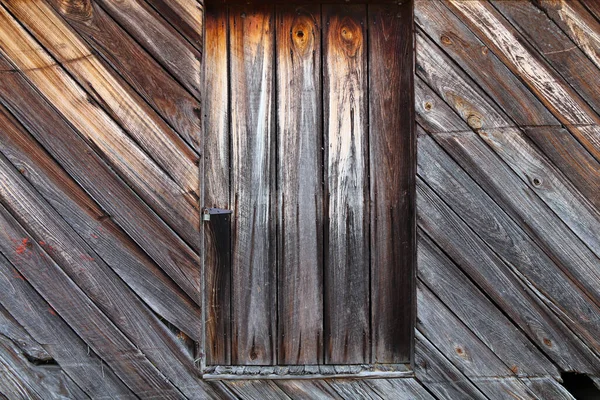 a wood timber pioneer homestead farm barn shutter window close-up