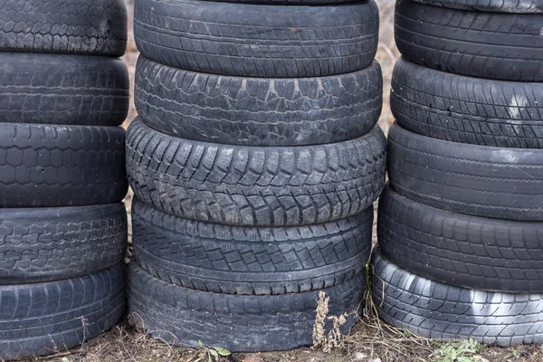 Old, worn car tires stacked on top of each other