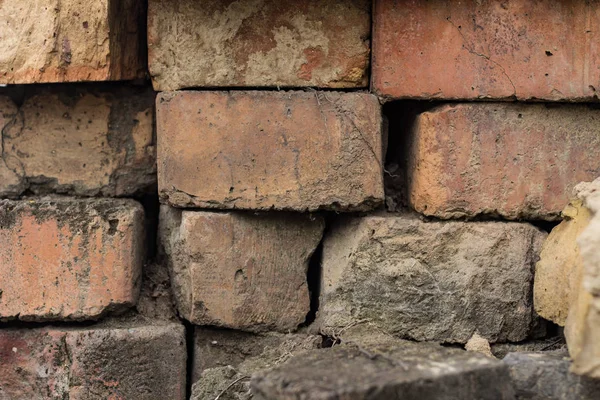 The brick texture, wall, with cracks and scratches can be used as a background