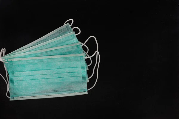 Surgical mask with rubber ear straps. Typical 3-ply surgical mask to cover the mouth and nose. Procedure mask from bacteria. Protection concept.