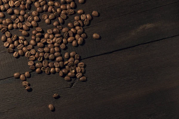coffee fried beans, on an old wooden background